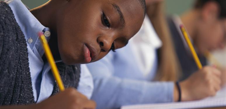 Child sitting at desk in school.